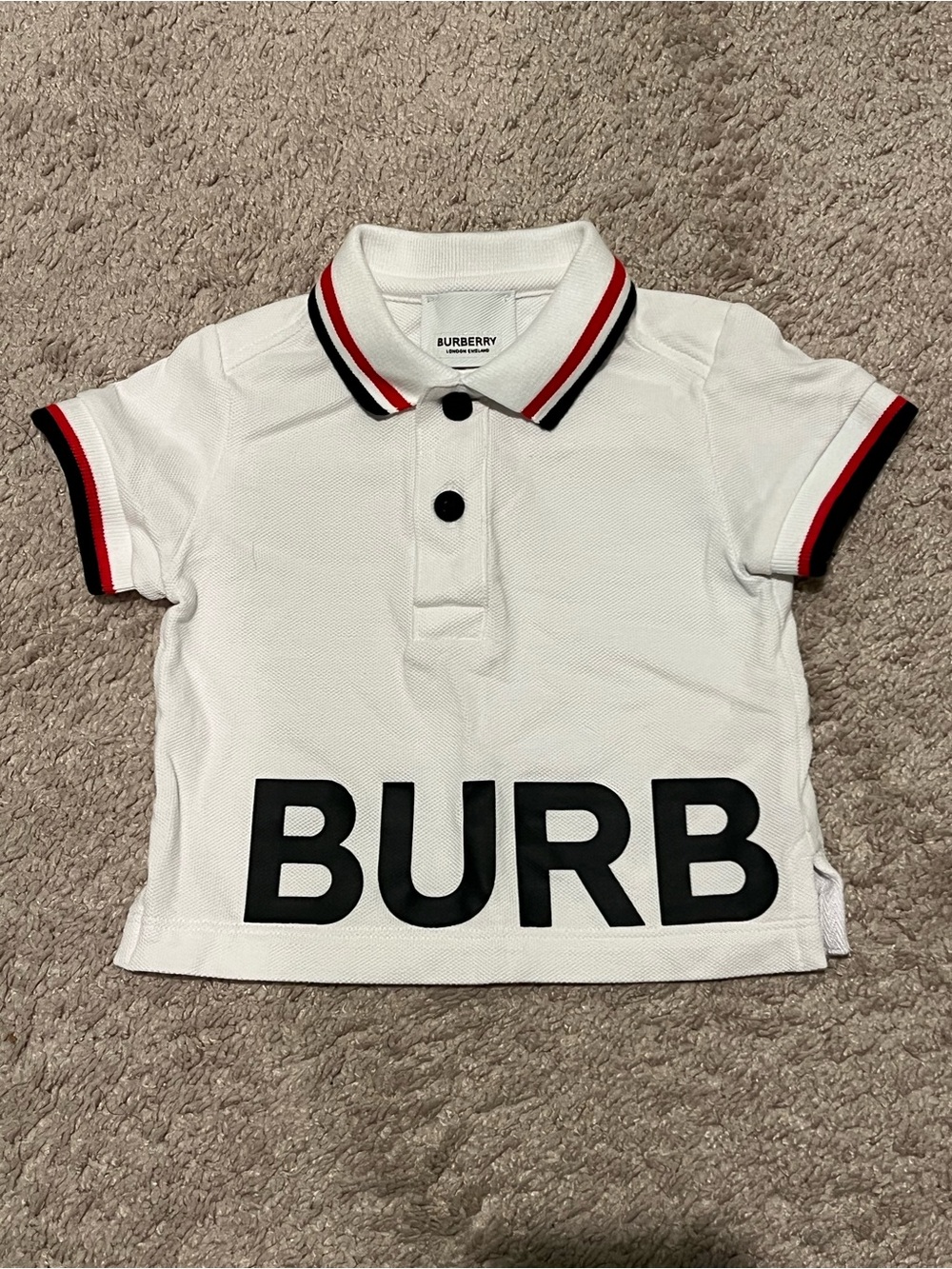 Burberry White Polo with Red and Black Stripe Trim - size 6 months